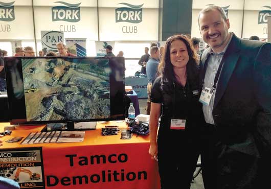 TAMCO Construction, Inc. President Tammy Johnson visits with a guest at a networking event sponsored by The Blue Book Network®.